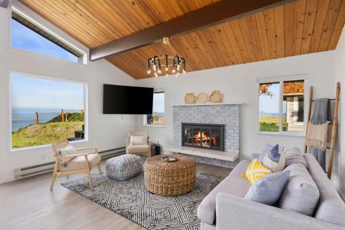 a living room with a couch and a fireplace at Island Hideaway with Stunning Ocean Views in Oak Harbor