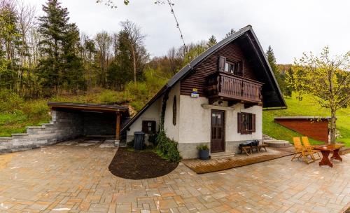 a small house with a porch and a patio at Kopiše in Zoll
