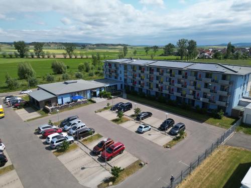 an aerial view of a hotel with cars parked in a parking lot at Vital Hotel an der Therme GmbH in Bad Windsheim