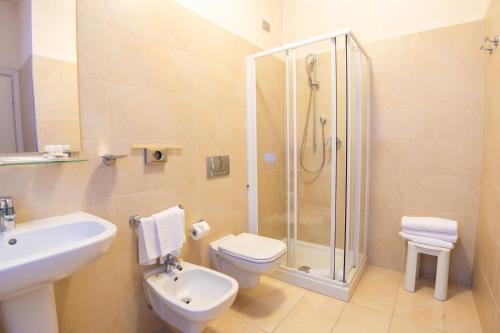 a bathroom with a shower and a toilet and a sink at Hotel Como in Como