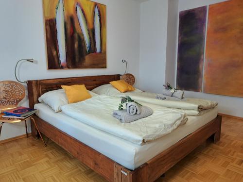 two beds in a room with paintings on the wall at Art & Living I House and Rooms in Schoneck