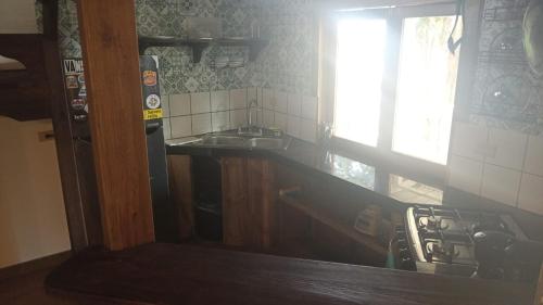 a kitchen with a stove and a sink and a window at Panama Dive School in Bocas Town