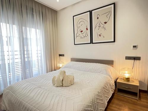 a teddy bear sitting on a bed in a bedroom at Dynasty Estate - Maarif residency in Casablanca