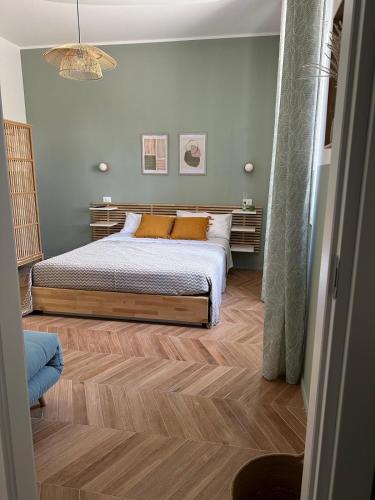 a bedroom with a bed and a wooden floor at Alloggio Turistico Soffiasale in Anzio