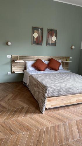 a bedroom with a bed and a wooden floor at Alloggio Turistico Soffiasale in Anzio