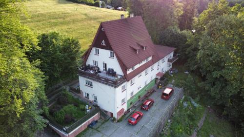 an aerial view of a large white house with cars parked in front at Jandlova Vila in Frenštát pod Radhoštěm