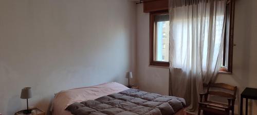 a bedroom with a bed and a window at Andrea in Mestre