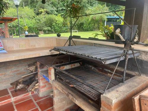 a metal bench sitting on top of a patio at María Ce - Cabaña familiar en el K25 vía al mar in Papagalleros