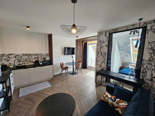a living room with a kitchen and a room with a couch at Horizon Vista - New - Premium - Parking in Świnoujście