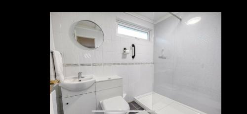 a white bathroom with a sink and a toilet at Kingfisher Holiday Park 1 Waveney Valley Great Yarmouth in Gorleston-on-Sea
