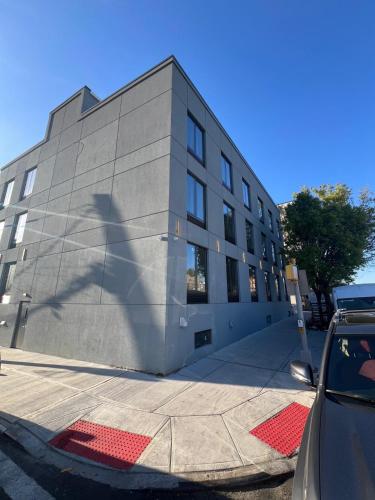 a building with a shadow on the side of it at Hotel Fuego Bronx in Bronx