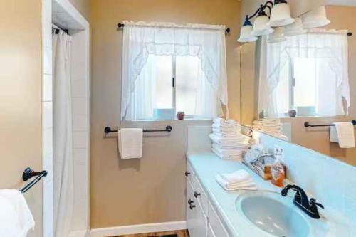 a bathroom with a sink and a mirror at Fox Lakeview Home in Bass Lake