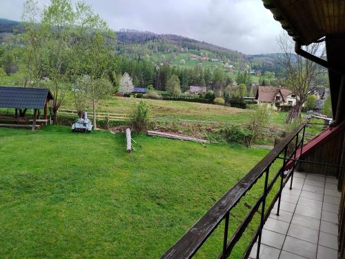 a view of a yard from a house at Chata Pod Kwiatkiem in Zawoja