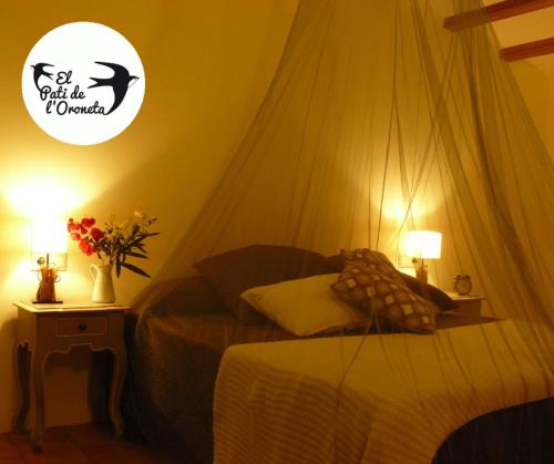 a bedroom with a bed with a mosquito net at El Pati de L´Oroneta in Els Ibarsos