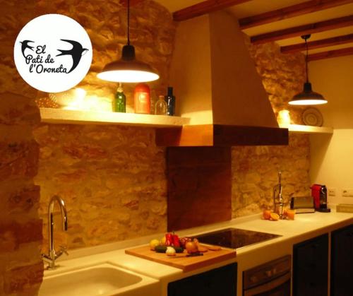 a kitchen with a sink and a counter top at El Pati de L´Oroneta in Els Ibarsos