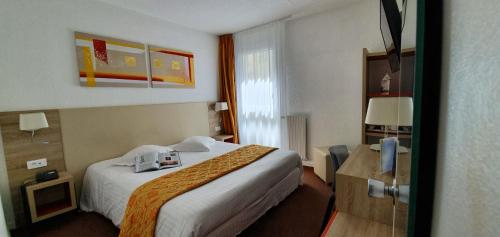 a hotel room with a bed and a window at Hôtel Windsor Contact Hôtel in Dieppe