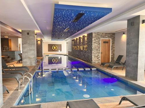 a pool in a hotel with chairs and a bar at The Best Apartment on the beach 'Caesar Beach' Bogaz, North Cyprus in Boğaz