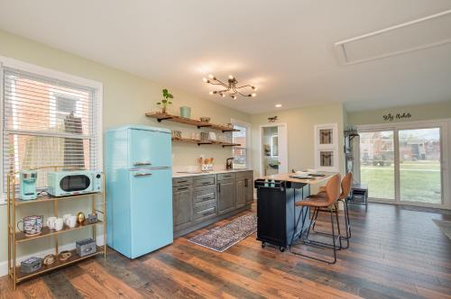 a kitchen with a blue refrigerator and a table at The Carriage House in Warsaw
