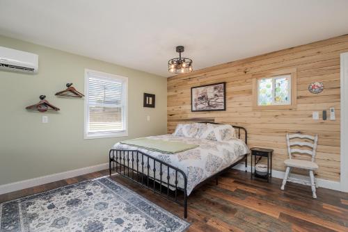 a bedroom with a bed and a wooden wall at The Carriage House in Warsaw