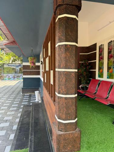 a building with red chairs and a pillar at ARABIAN HOLIDAY RESORT WITH SWIMMING POOL IN IDUKKI Calvary Mount in Idukki