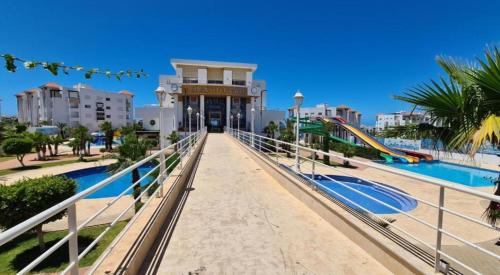 a view of a resort with a pool and buildings at Bel Appart Marina Golf Asilah in Asilah