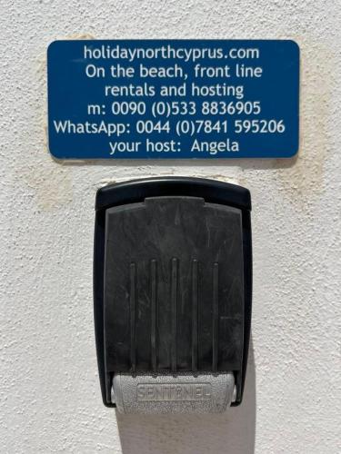 a sign on a lightswitch on a wall at The Best Apartment on the beach 'Caesar Beach' Bogaz, North Cyprus in Boğaz