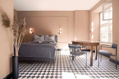 a bedroom with a bed and a table and chairs at Elegant Apartment in the City Center in Wrocław