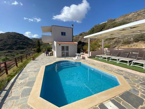 a villa with a swimming pool and a house at Vaia Villas in Mochlos