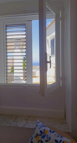 a room with a window with a view of the ocean at Villa dei fiori B&B in Capri