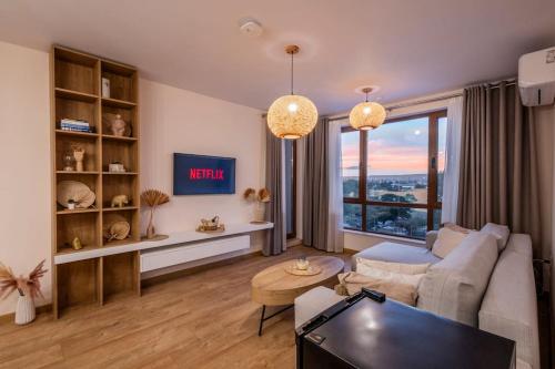 a living room with a couch and a table at Marina Varna Apartment-2BDR at South Bay Complex in Varna City