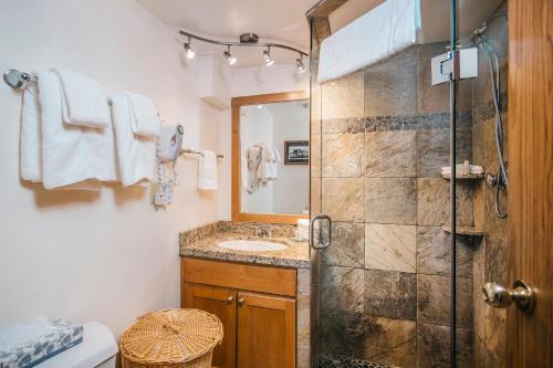a bathroom with a shower and a sink at Carleton Lodge in Whistler