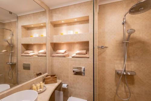 a bathroom with a shower and a toilet and a sink at Marina Varna Apartment-2BDR at South Bay Complex in Varna City
