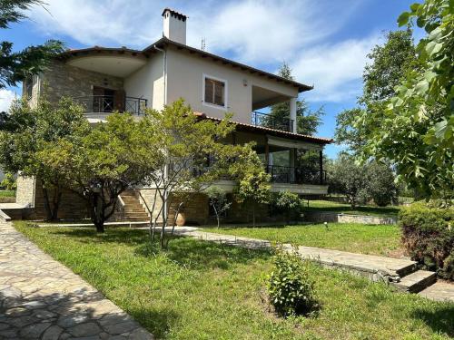 a large white house with trees in front of it at Zeusplace karia Villa Natura in Leptokaria