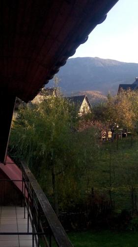 a balcony of a house with a view of a field at Chata Pod Kwiatkiem in Zawoja