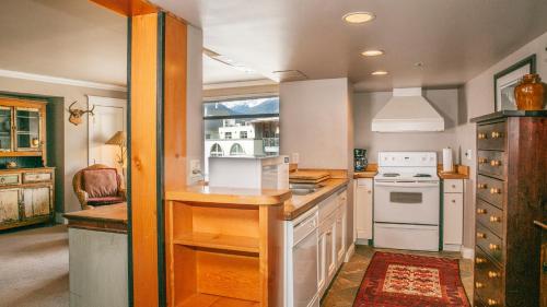 a kitchen with white appliances and a window at Carleton Lodge in Whistler