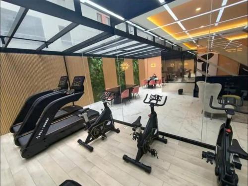 a gym with three exercise bikes in a room at Luxury Building Studio - XOE in Quito