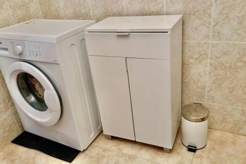 a white washer and dryer in a bathroom at Wagner - Beach - Appartement in San Marcos