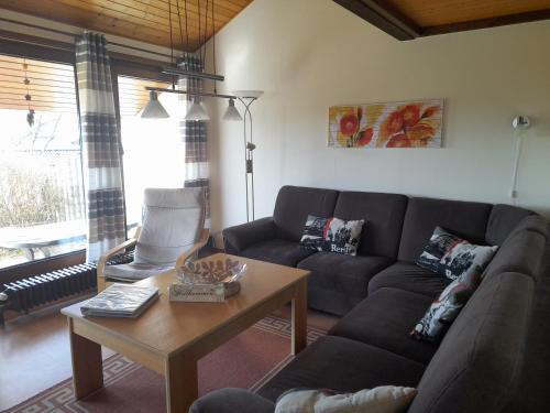 a living room with a couch and a coffee table at Villa Leni im Schwarzwald in Bad Dürrheim