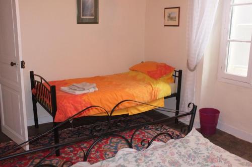 two twin beds in a room with a window at La Maison Bleue in Exideuil