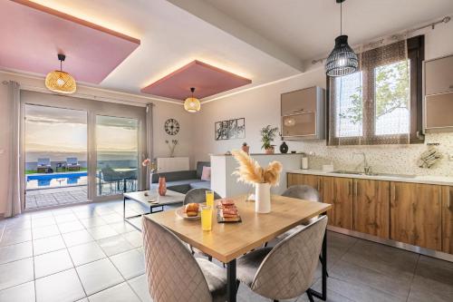 a kitchen and dining room with a table and chairs at Iliovasilema Luxury Apartment in Heraklio Town