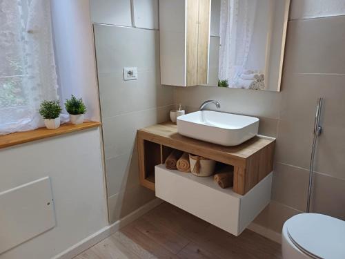 a bathroom with a sink and a toilet at Dentro le Mura-Suite House in Sassari