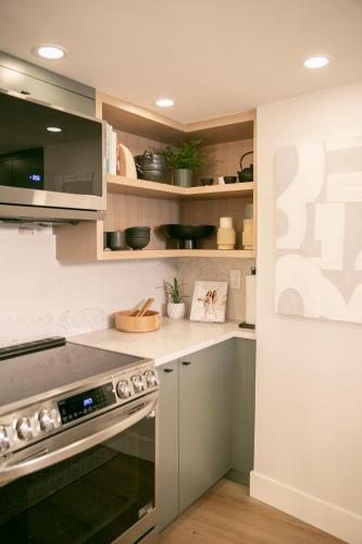 a kitchen with white cabinets and a stove at Carleton Lodge in Whistler