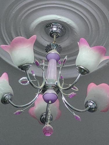 a chandelier with pink and white flowers on a ceiling at Egypt valy in Kafr Şaqr