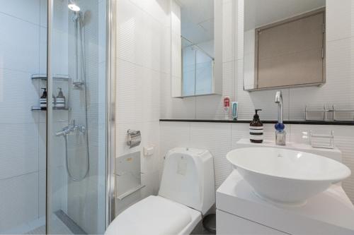 y baño con aseo, lavabo y ducha. en Mirae_stay 36 New Open 2 Queen+1 S-Single, en Seúl