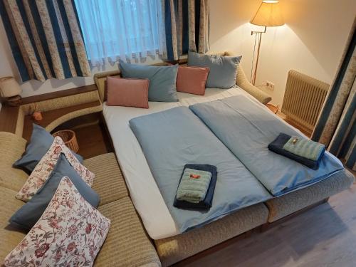 a large bed in a room with pillows on it at Nassfeld and Lake Apartment in Hermagor