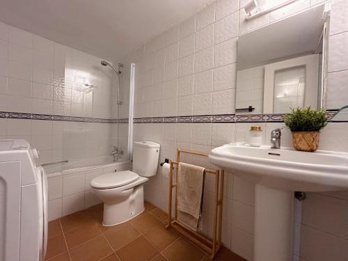 a white bathroom with a toilet and a sink at Casa Barman Casco Antiguo Y Vistas Al Mar in Altea