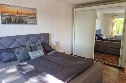 a bedroom with a bed and a living room at 'Allgäus Finest Place '-Domizil zum Träumen und Erholen in Leutkirch im Allgäu