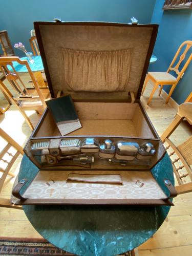a wooden suitcase sitting on top of a table at VASILIKON Hotel 1888 the past is present HISTORICAL PRESERVATION MONUMENT in Kalamata