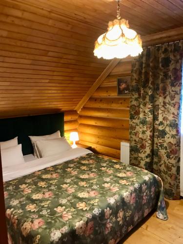 a bedroom with a bed in a wooden room at Cottage Lavanda окремий котедж з каміном in Bukovel