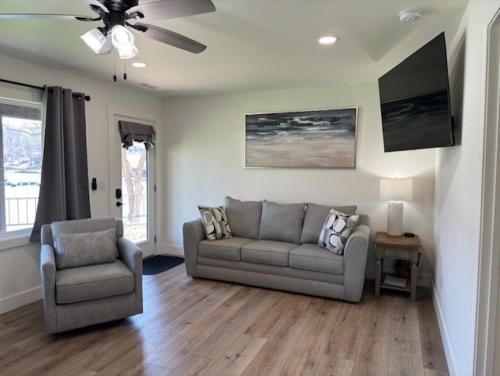 a living room with a couch and a chair at Sunset Beach Resort in Osage Beach